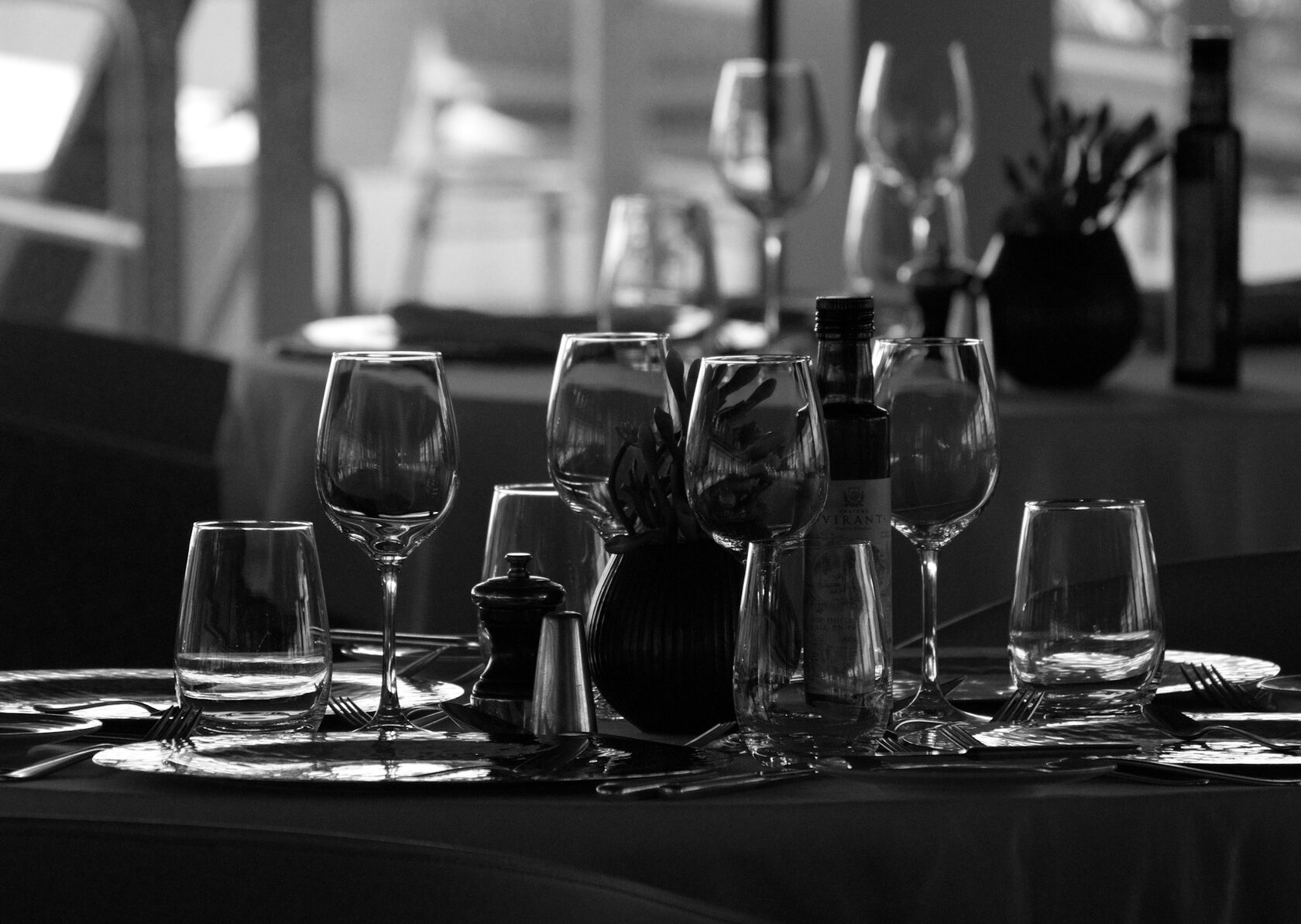 Bottles of Lucky Hills wine arranged on a timber table in the cellar