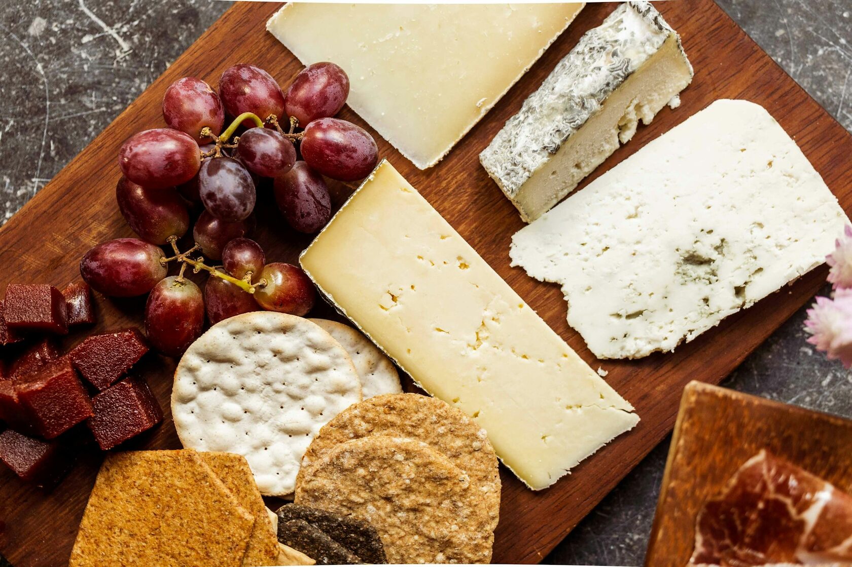 A tasting board of local produce set alongside wine